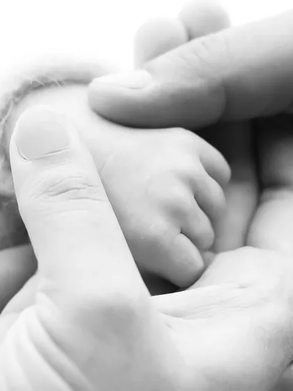 What forevers look like. This black and white macro shot of a baby's tiny hand held by parents is a powerful and artistic way to remember how small they were.
