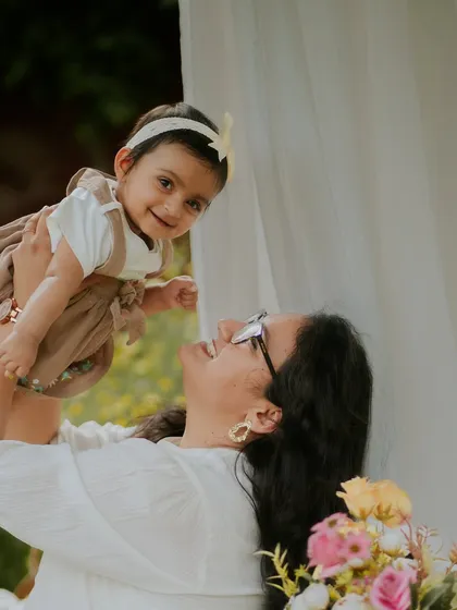 A mother's love, lifting her daughter up. This joyful shot is full of light and happiness.