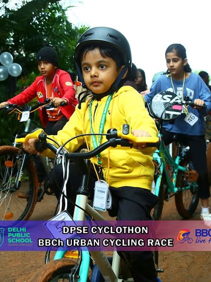 A young girl in a yellow jacket shows her racing spirit. I am passionate about creating opportunities for children to engage in healthy, competitive sports.