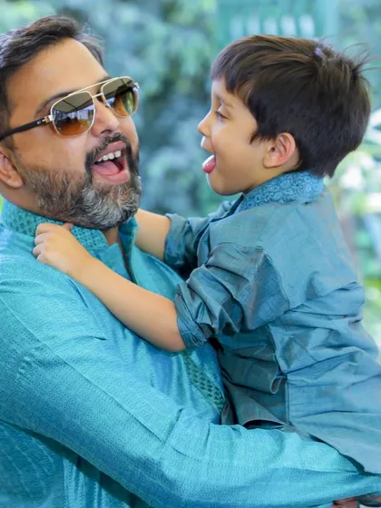 A playful, unposed photograph of a father and son sharing a laugh. My goal is to capture these genuine interactions that truly represent your family's unique personality and bond.