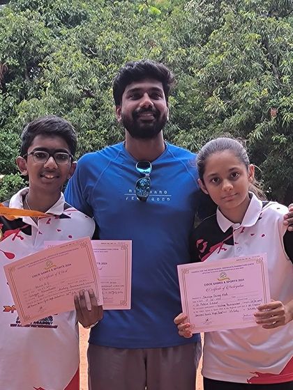 Individual achievements are a core part of our journey. Two of our dedicated students showcase their certificates of participation and medals, marking their successful performance in a competitive event.
