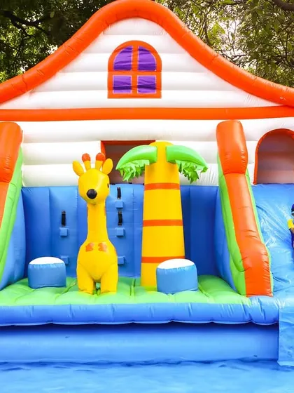 A fantastic inflatable house with a slide leading into the pool. These large structures are always a huge hit and serve as a great centerpiece.