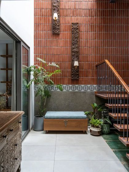 The 'Vṛttānta!' residence features a central courtyard with a skylight, bringing much-needed natural light into the home and highlighting the exposed brick wall.