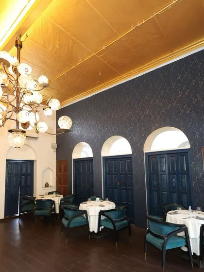 Our indoor dining room is a sanctuary of quiet elegance. The gold-leaf ceiling, bespoke chandelier, and rich textures create a luxurious and intimate setting for a memorable meal.