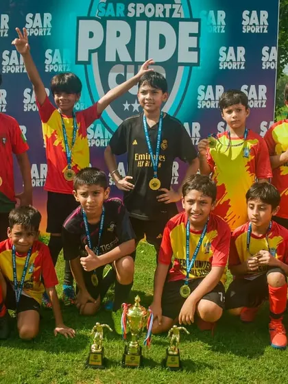 A group of proud young players shows off their medals and trophies after the Pride Cup.