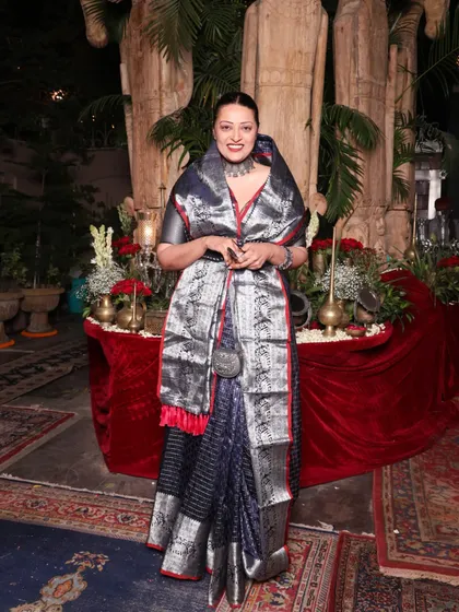 The full effect of the Rajput-inspired saree drape. The way the silver stole is worn adds structure and a sense of ceremony to the look.