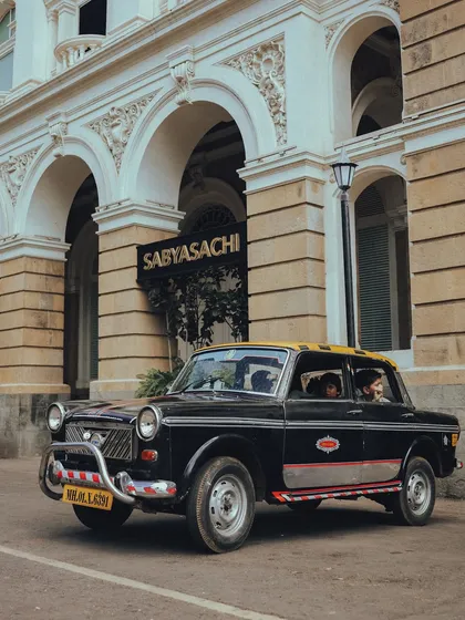 A "kaali-peeli" taxi waiting outside the Sabyasachi store in Mumbai. A beautiful blend of classic transport and high-end fashion.