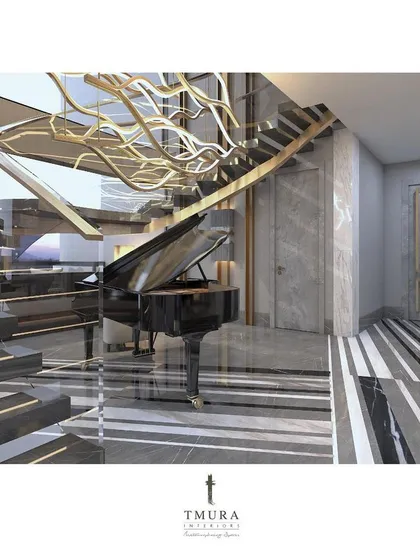 Luxury living is a multi-sensory experience. Here, a grand piano becomes the heart of the home, positioned beneath a custom-designed, wave-like chandelier and a floating staircase, turning an architectural feature into a piece of art.