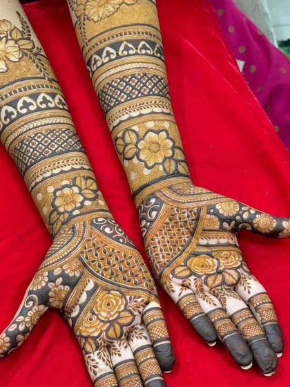 The complete floral design, extending from the arm bands down to the palms and fingers with delicate rose and leaf patterns.