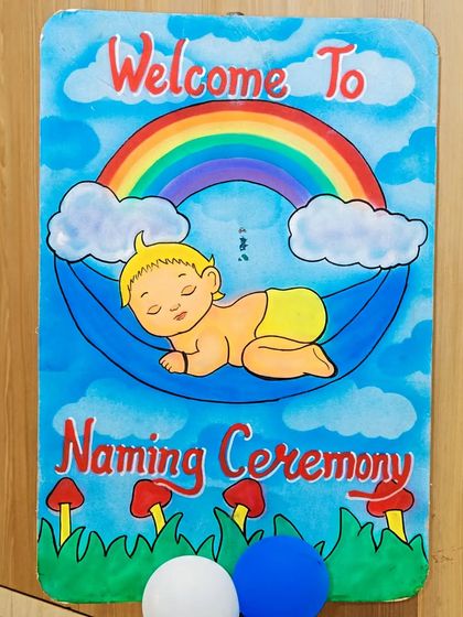 A charming hand-painted welcome board for a naming ceremony. These personalized touches make your event feel unique and special for you and your guests.