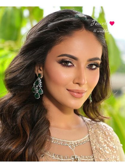 A close-up on these stunning emerald and diamond chandelier earrings. They are designed to catch the light with every movement, ensuring you sparkle all night long.