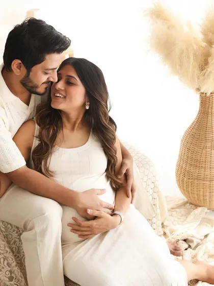 The connection between them is the focus of this intimate portrait. Seated together amidst the soft textures of the boho set, their love for each other shines through.