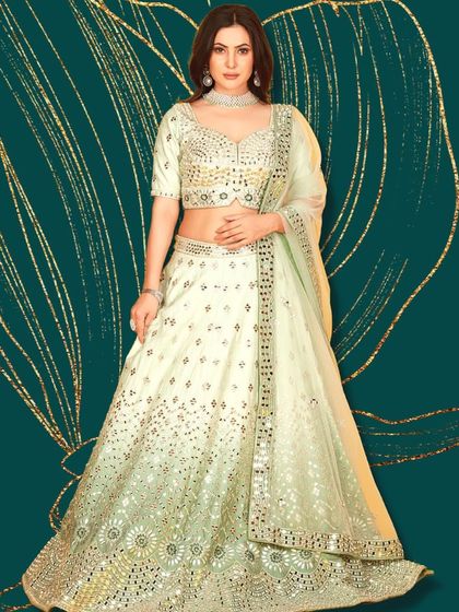 A chic and modern pastel green lehenga with mirror work. This is a sophisticated choice for a reception or engagement party.