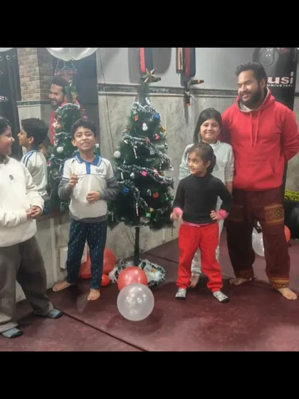 Posing with the kids by the Christmas tree. These moments of fun and celebration strengthen the bonds within our dojo.