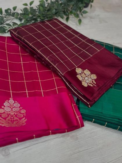 A three-color display of our checks pattern Banarasi sarees in rani pink, maroon, and green.