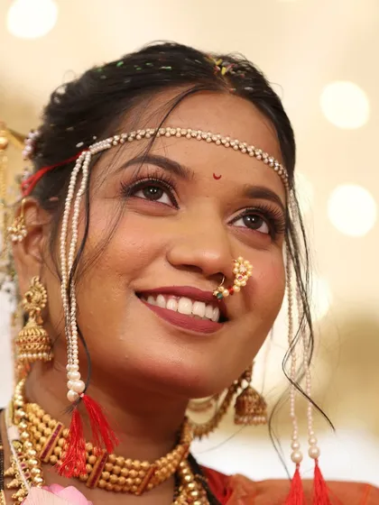 A close-up of the bride's happy face. The makeup is natural and glowing, perfect for capturing the emotions of the day.