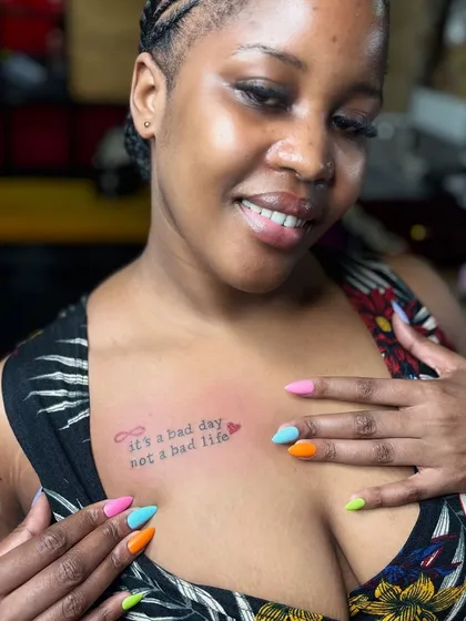 The happy client showing off her new chest tattoo and colorful nails. We love creating a positive and friendly vibe in the studio.