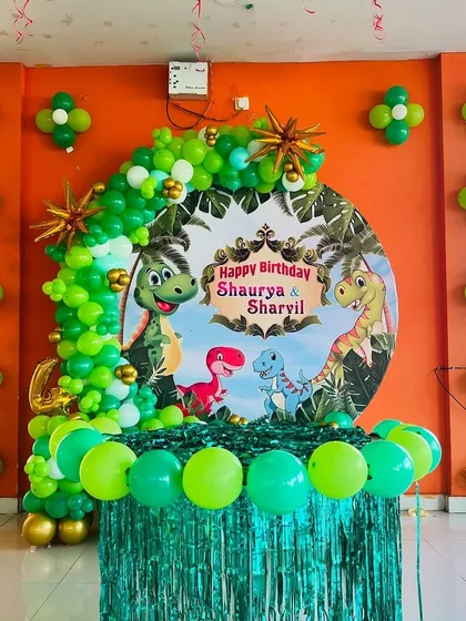 We bring kids' party themes to life with vibrant, detailed decorations. This jungle-themed birthday features a custom dinosaur backdrop, a lush green balloon arch, and matching balloon clusters to create an exciting atmosphere for the little ones.