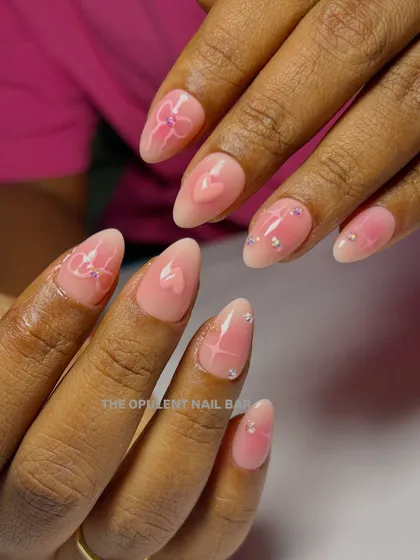 I'm a huge fan of the coquette aesthetic, and these nails are a dream. This set features a soft pink aura base, delicate 3D bows, tiny hearts, and a sprinkle of sparkle for that perfect finish.