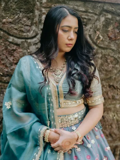 A pensive moment captured during a pre-wedding shoot. Her soft glam makeup with defined eyes and a neutral lip looks timeless and elegant.