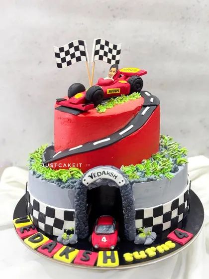 A Ferrari-themed cake with a see-through tunnel, a fun feature for a car-loving kid. This whipped cream cake with fondant accents travelled safely to its destination.