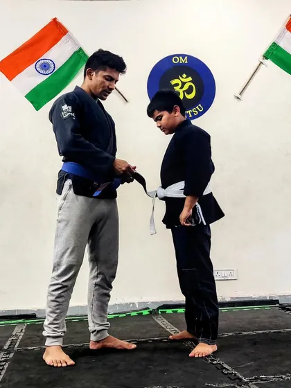 Tying on a new stripe for this dedicated student. Each stripe represents a step forward in his Jiu-Jitsu journey, marking his improvement and commitment.