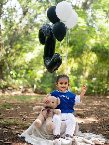 Waving hello to year two. This portrait captures the friendly and cheerful nature of the birthday boy during his outdoor shoot.
