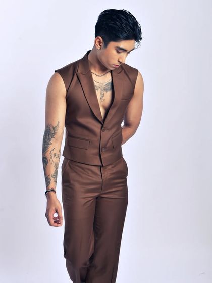 A contemplative, quiet moment. This pose highlights the cut of the vest and the model's physique.