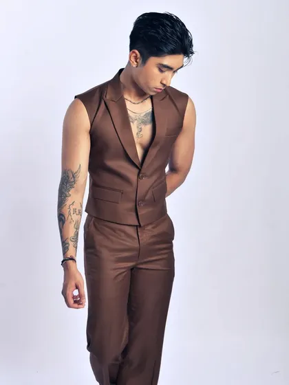 A contemplative, quiet moment. This pose highlights the cut of the vest and the model's physique.