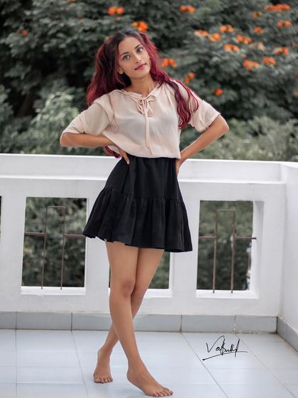 A full-length casual portrait from our balcony shoot. The model's confident stance and simple, stylish outfit are perfect for capturing a relaxed, everyday fashion look.