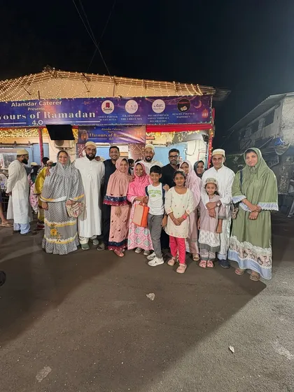 A large family group smiling for a photo. We welcome big groups and are happy to accommodate them for Iftar parties.