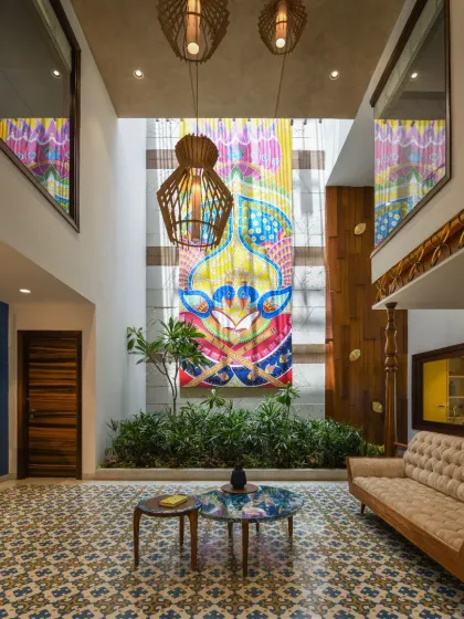 The heart of the Ashraya Residence is this double-height courtyard, where a 28-foot painting of Lord Krishna becomes a spiritual and visual anchor. The space is a modern interpretation of the traditional Indian 'aangan', filled with light, art, and life.