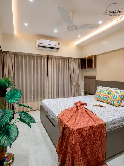 A wide shot of the bedroom, showing the placement of plants to add a touch of freshness.