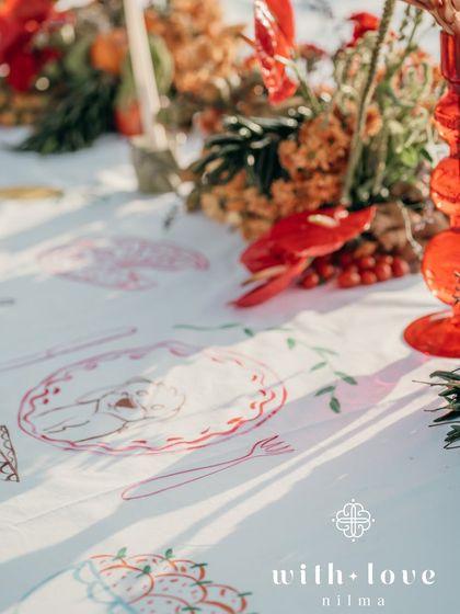 The interactive table overlay, where guests could paint illustrations of the couple's favorite things, like pizza and travel.