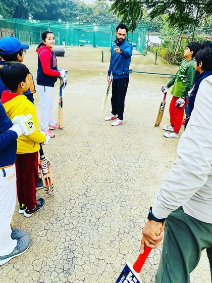 A coach giving instructions to the team. Clear communication and strategy are key components of our group coaching sessions.