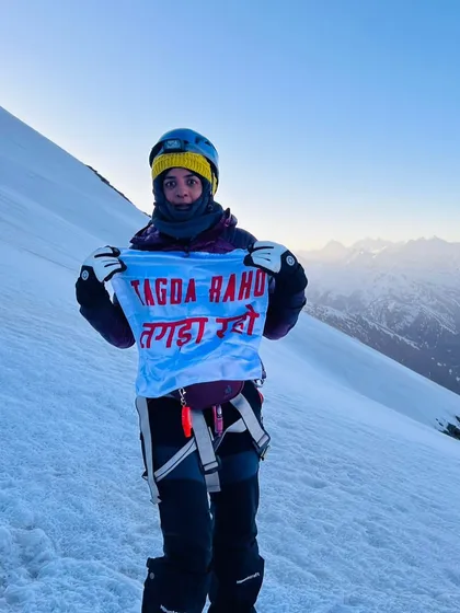 One of our earliest members, who quietly built her strength rep by rep, stands at 5000m holding our flag. Her journey is proof that what we're building is more than a workout; it's a way of being that empowers you to reach your peak.