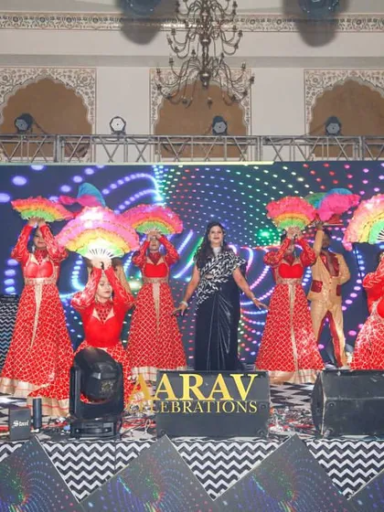 A colorful family performance using multi-colored fans as props. This adds a beautiful wave of color and movement to the stage, enhancing the visual appeal of the dance.