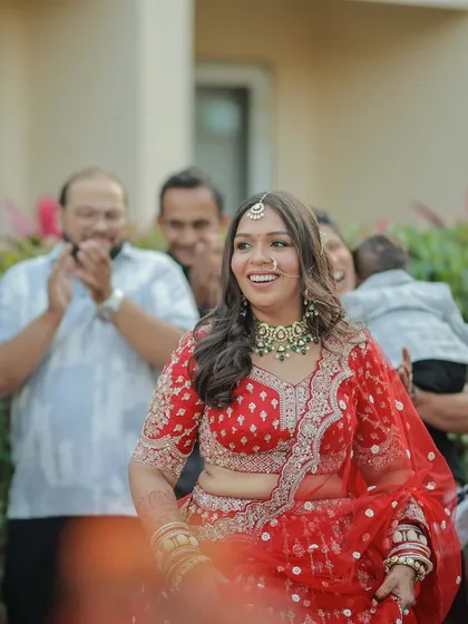 The bride's joyful entrance. Her smile says it all, and her radiant makeup just enhances her natural happiness.