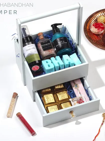 For a truly special gift, I designed this two-tier wooden basket hamper. The top holds all the organic skincare essentials for your bhai, while the drawer reveals handmade chocolates and a rakhi.