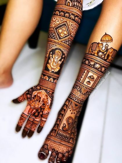 This full bridal set includes portraits, a Ganesha figure, and elephants, creating a complete and auspicious design.