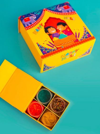 This bright yellow Holi box opens to reveal four sections filled with colorful herbal gulal. It's a simple, safe, and beautiful gift for the festival of colors.
