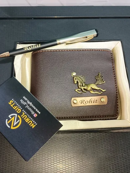 A personalized brown leather wallet with a horse charm, paired with a name-engraved pen.