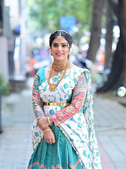 Preethi's complete look for her daughter's naming ceremony. The makeup is kept elegant to balance her colorful and artistic lehenga.