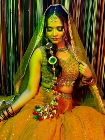 Another angle of this festive party look. The yellow outfit and traditional jewelry are perfectly complemented by the glowing makeup and detailed eye work.