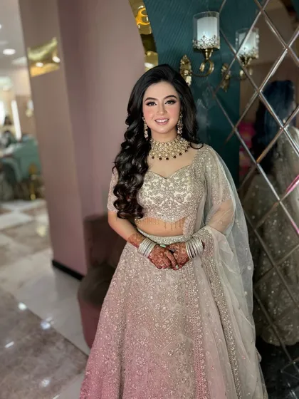 A soft pink glam look for my beautiful client. The silver lehenga is complemented by soft makeup and voluminous curls.