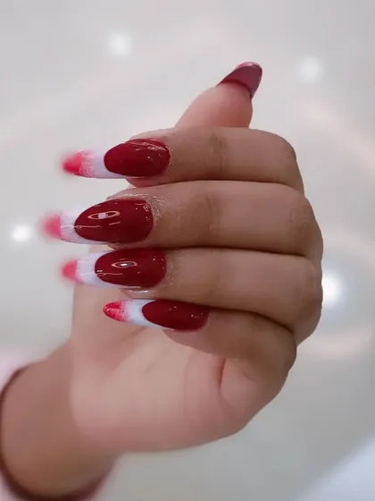 A side view of the striking red and white abstract nails.