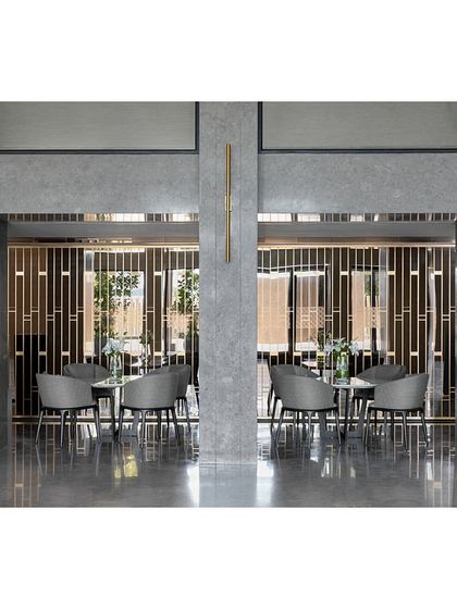 A view through the decorative metal jali into a semi-private seating area at the Blue Sea Banquet. This design element adds a layer of visual interest and provides a sense of intimacy within the larger banquet hall.