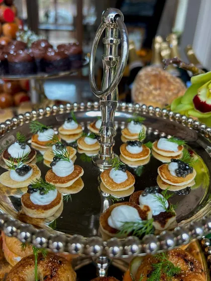 Beyond meal delivery, we curate extraordinary catering experiences for the most exclusive events. This tiered display of caviar blinis and gourmet canapés from a luxury Champagne & Caviar brunch showcases our commitment to elegance and sophistication.