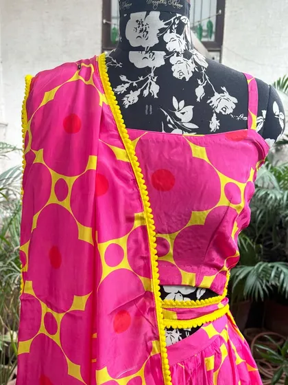 A close-up of the printed fabric and the delicate yellow lace trim.