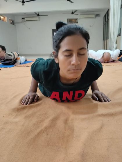 A close-up of a participant in Bhujangasana, her focus entirely inward.